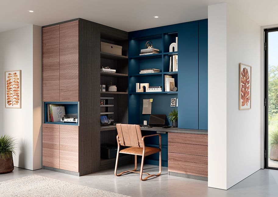 Custom built-in corner office in blue wood finish with desk and shelves by California Closets