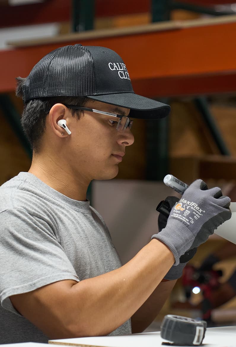 Production technician working on boards at California Closets
