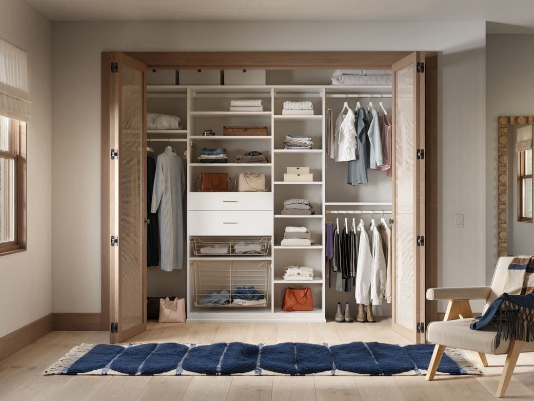 Reach in closet custom doors for drawers, with open shelving, long and short hanging wardrobe bars and closet organizers by California Closets