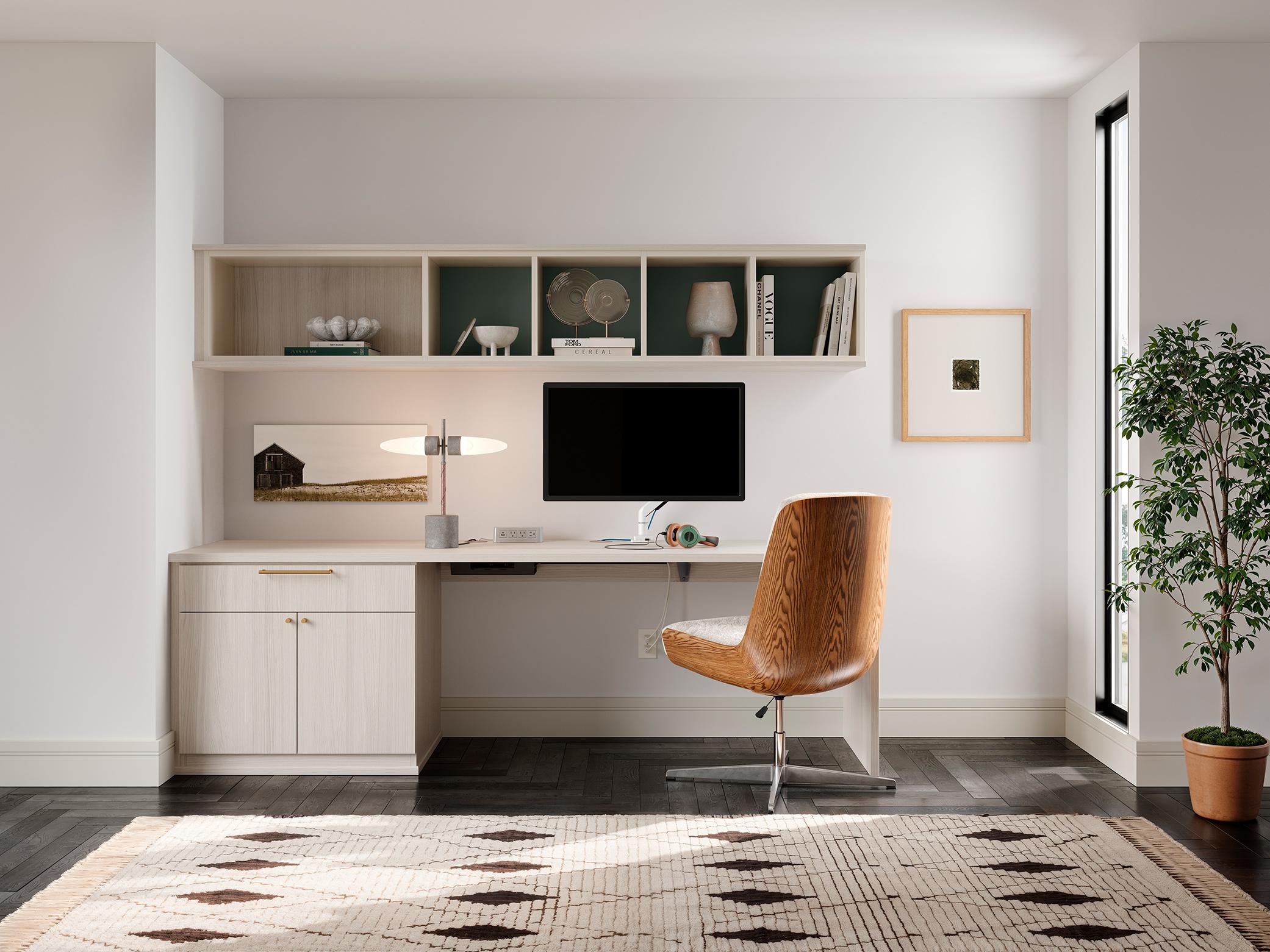 Custom home office desk with hidden drawers and built-in cabinet storage in a bright workspace