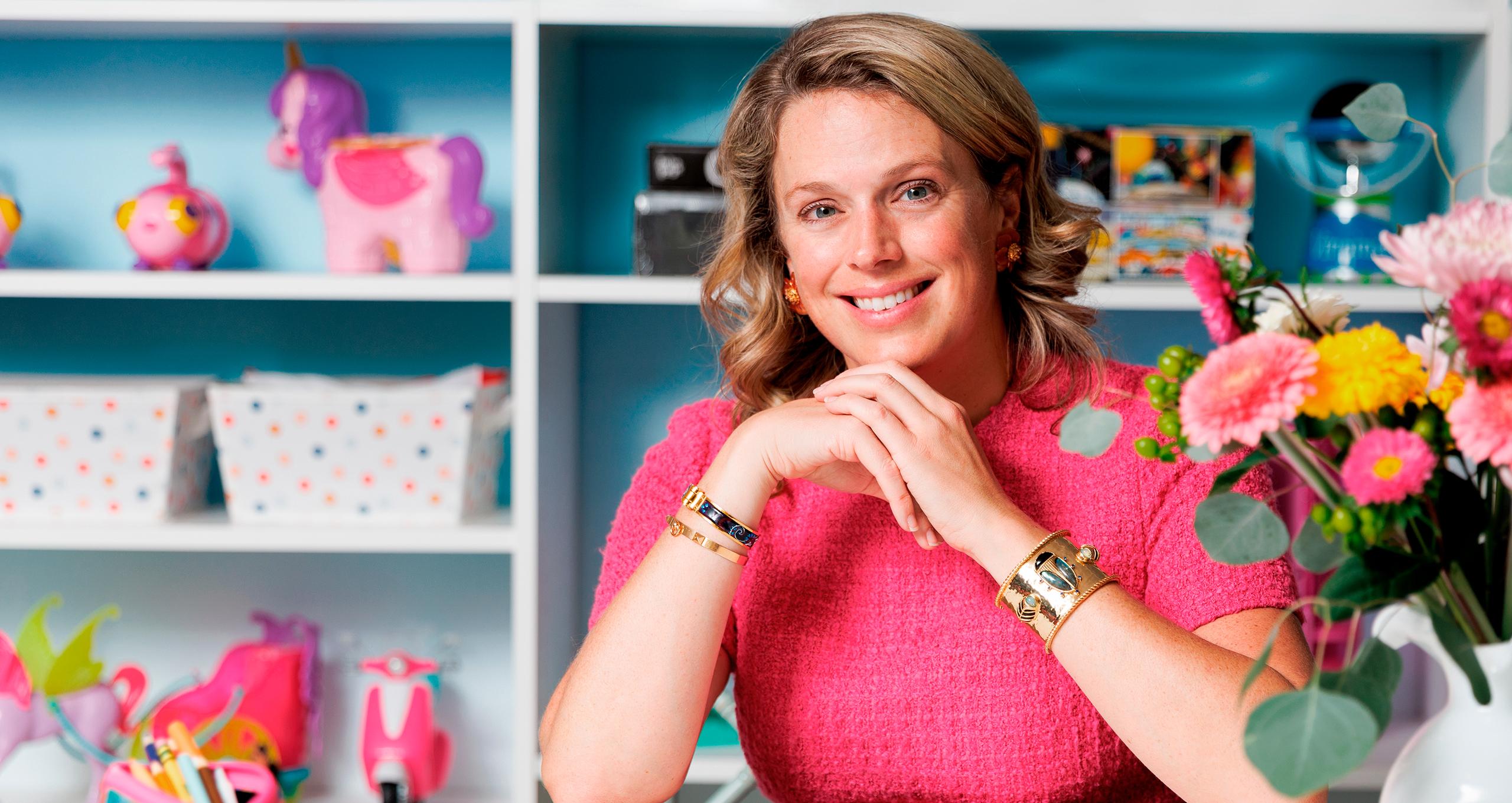 Colorful playroom shelving with storage bins and flowers, custom storage by California Closets