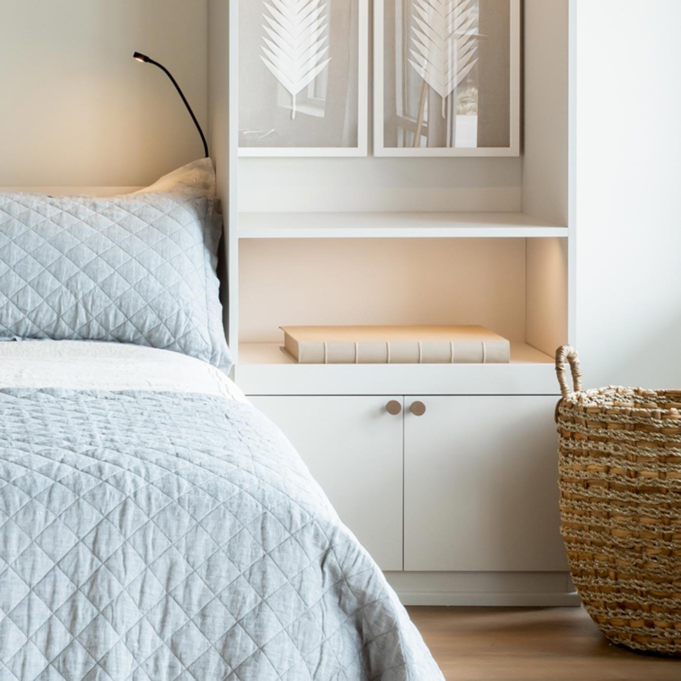 Custom wall bed buil in with pull out shelves and storage space in a white finish by California Closets