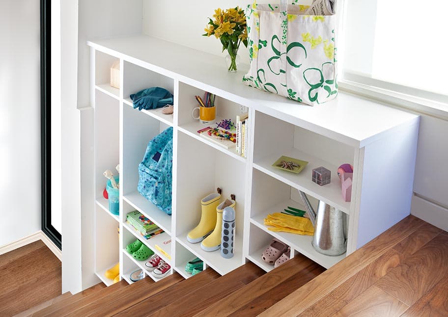 Custom storage space idea for up the stairs design by California Closets