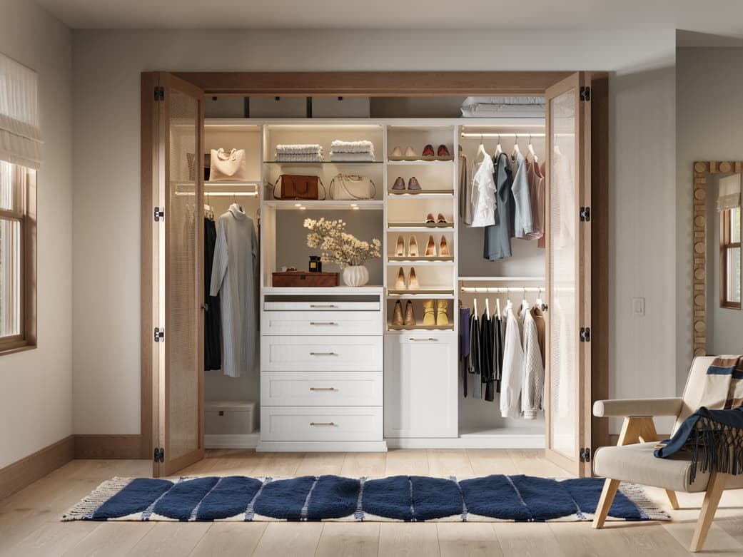 Custom reach in closet with lighting, drawers accessories by California Closets