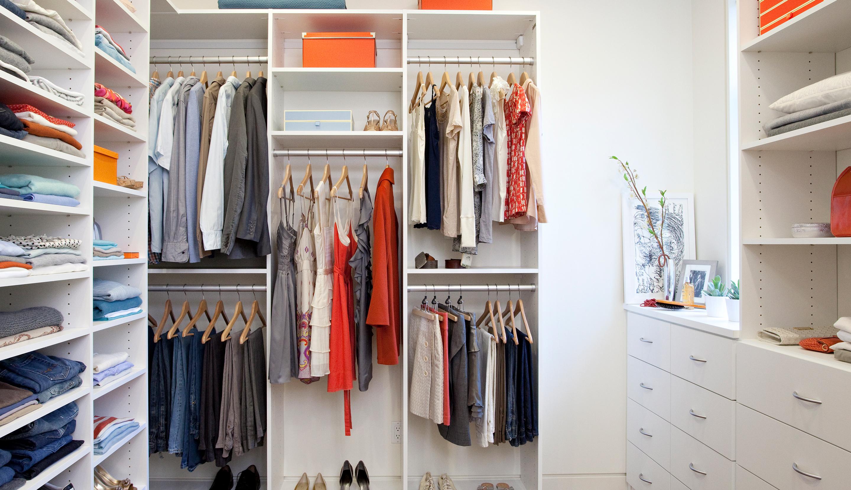 After custom closet redesign in a white finish with custom cabinets by California Closets