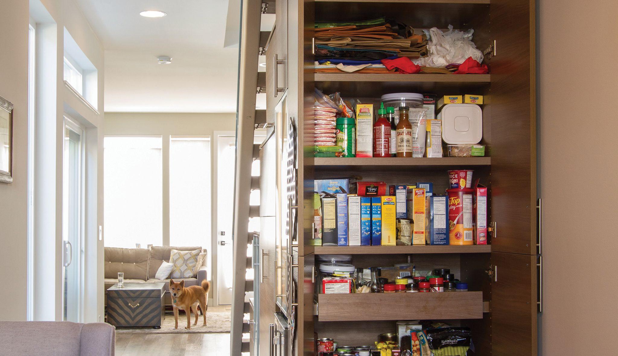 Mini pantry built with shelving in dark finish by California Closets