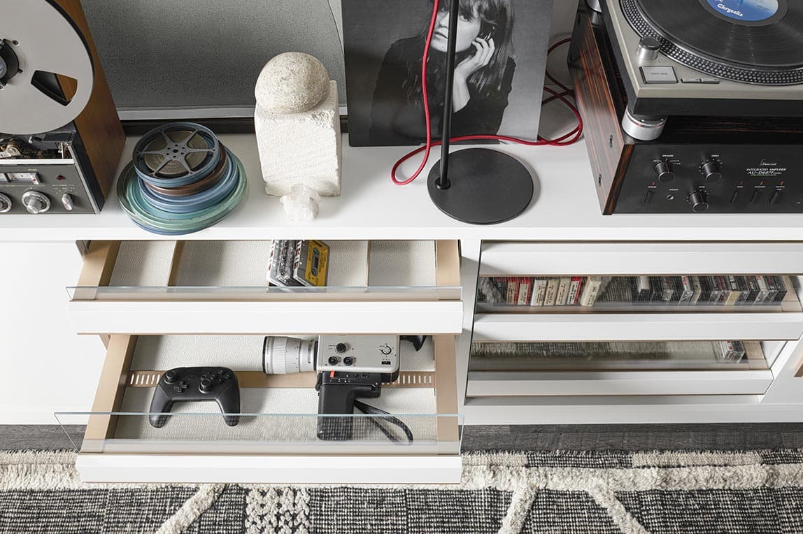 Custom media drawer storage in a white wood finish California Closets