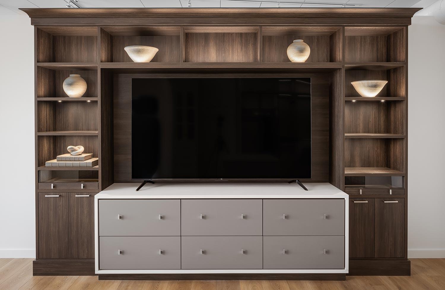 Customized white storage drawers for custom entertainment center dark wood finish by California Closets