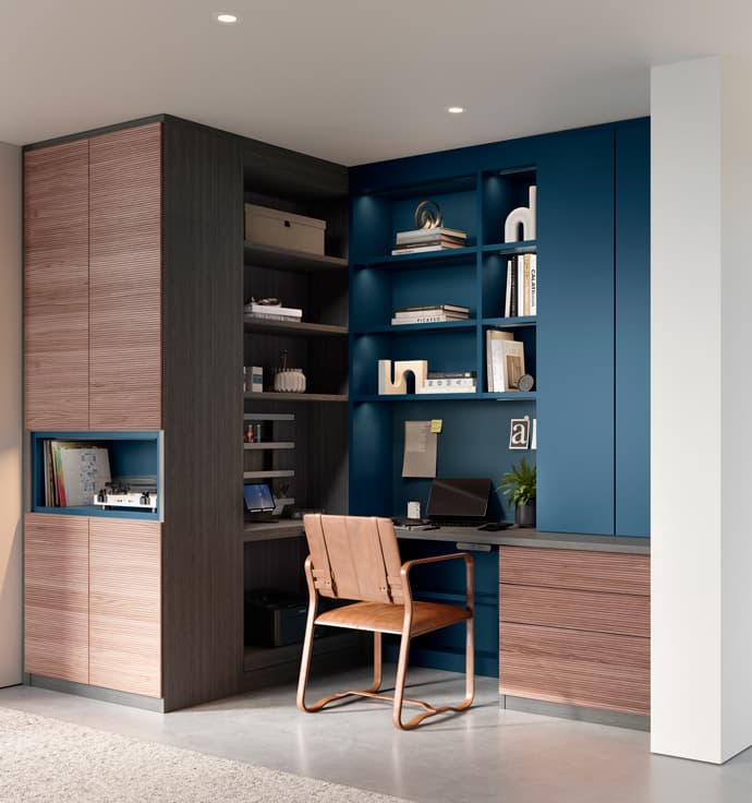 Home office in a small corner space with vertical shelving and cabinets to maximize storage by California Closets