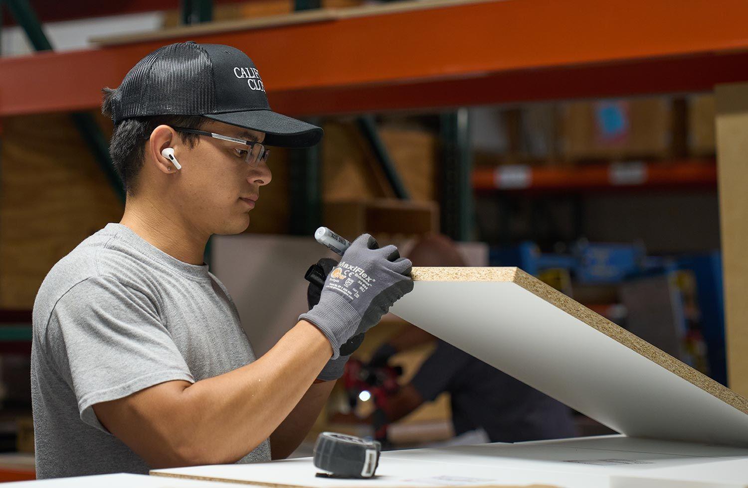 Worker at the warehouse creating custom materials and finishes for California Closets