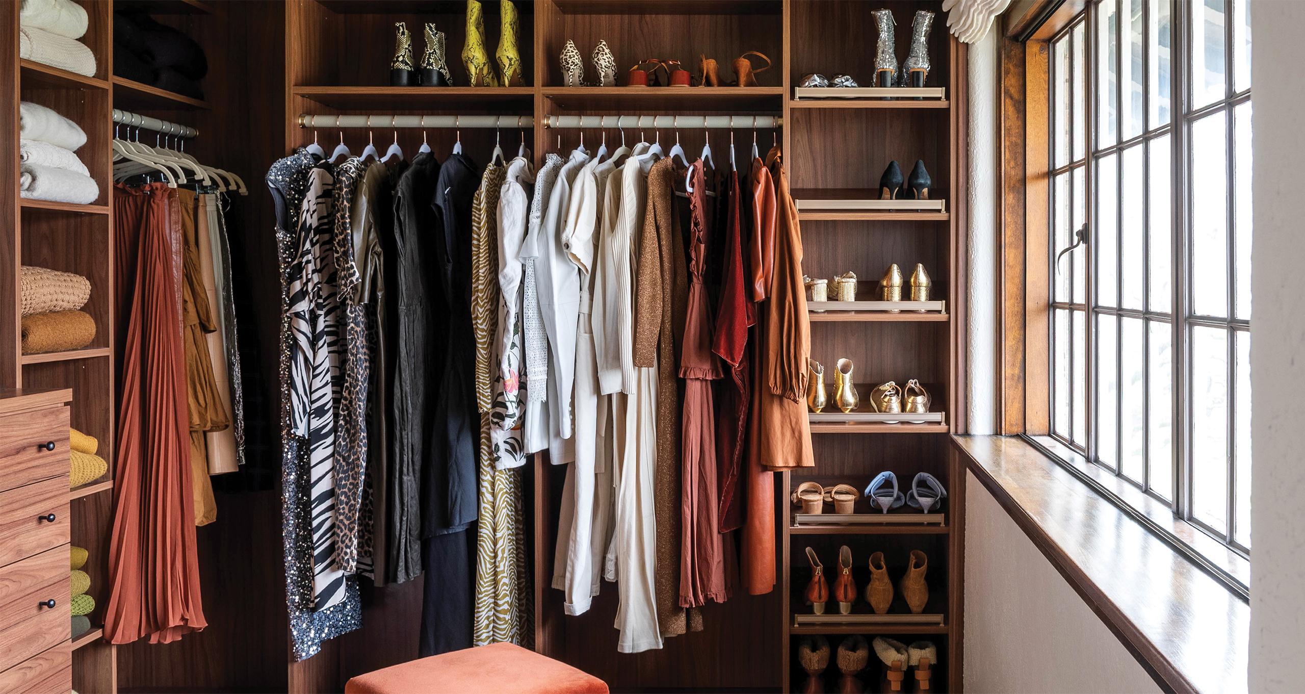 Walk-in-closet designed with open shelving, long-hanging wardrobe space, shoe storage and built in dresser from California Closets