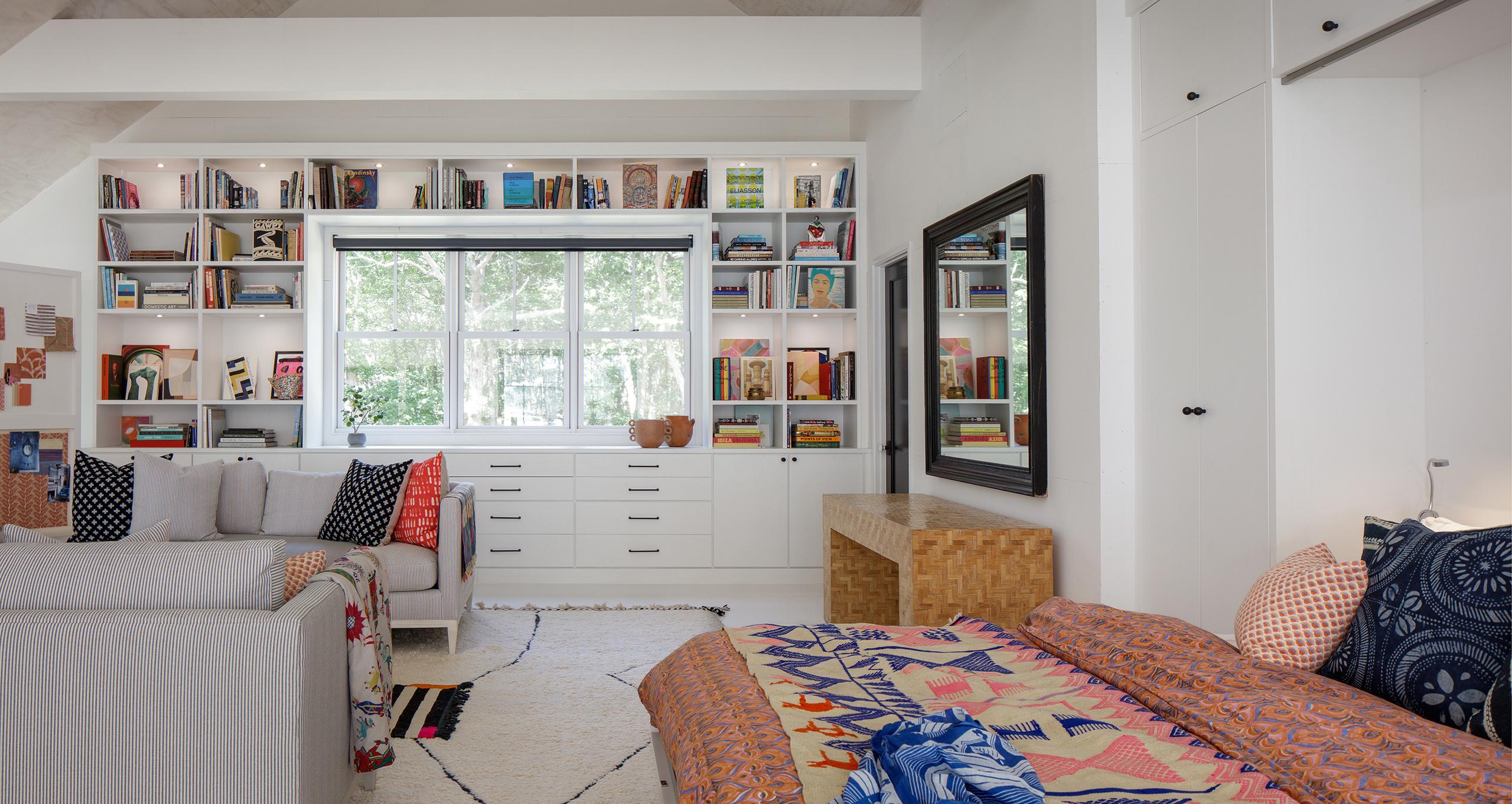 Opened wall bed doubles function for this artistic barn loft-like studio with built in bookshelves and art supply storage from California Closets