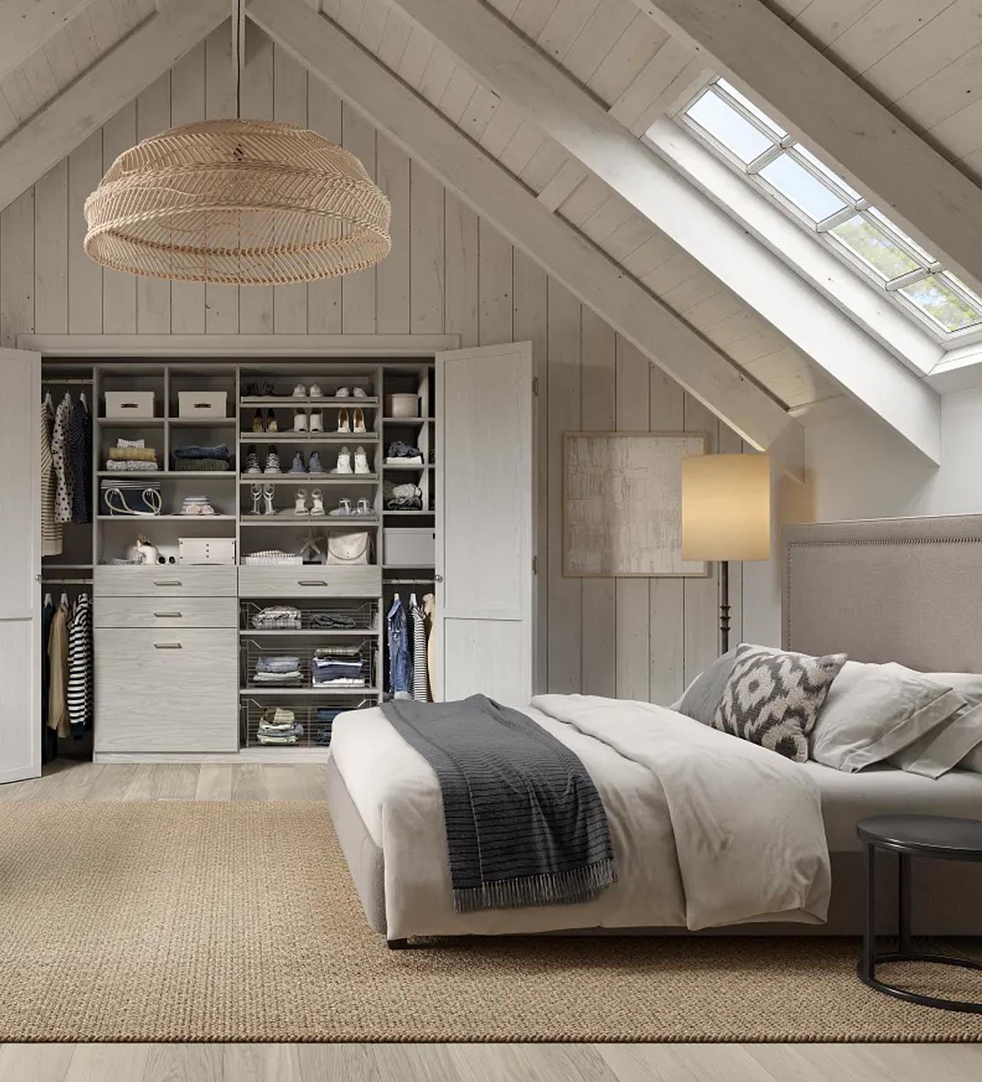 Wardrobe closet installed with custom-built cabinets, counterspace and drawers by California Closets