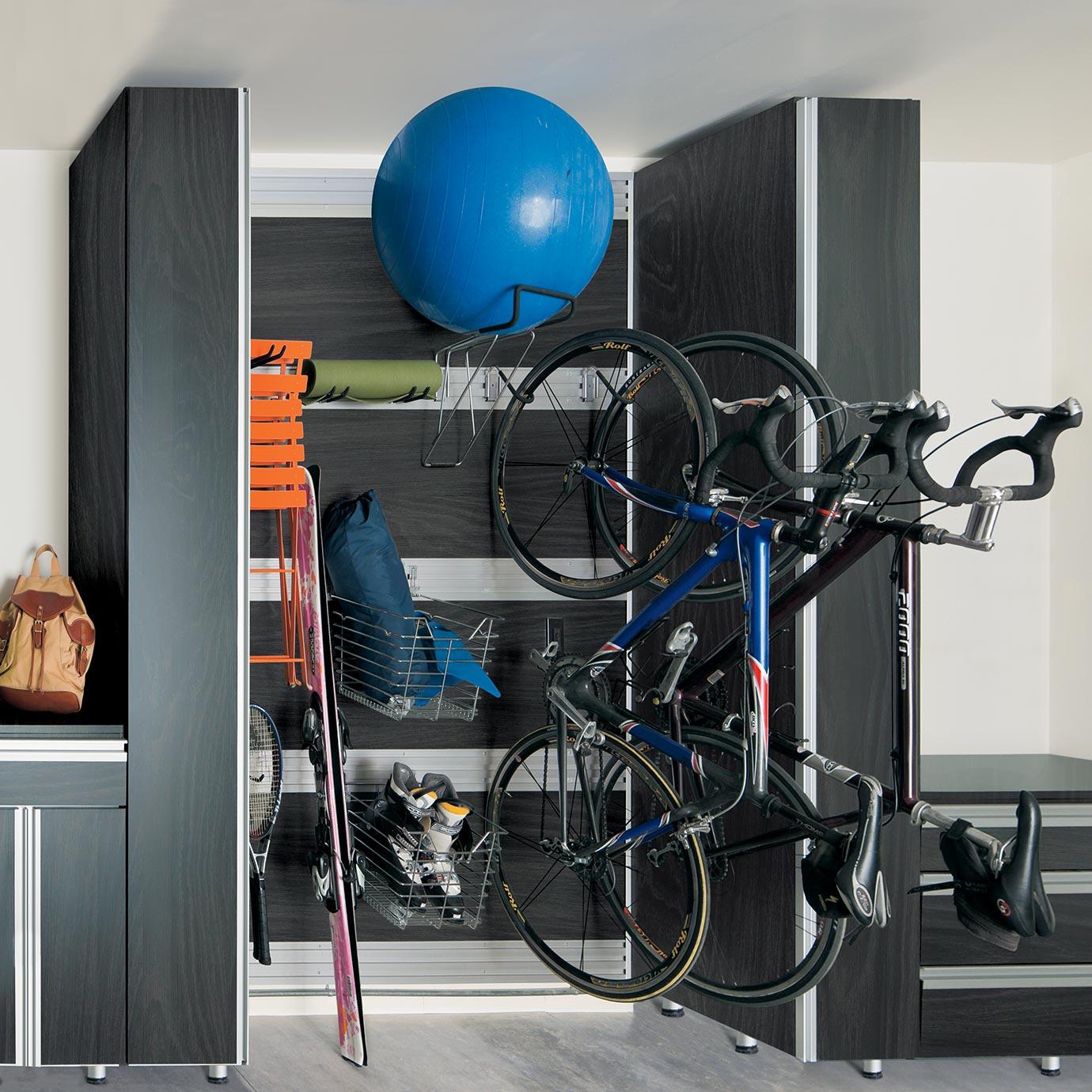 Custom garage storage solutions for your home with fusion trackwall for sports equipments and yard tools by California Closets