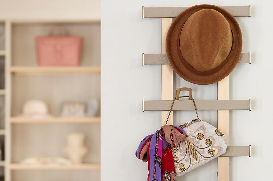 Customized closet it with wall rack for organizing belts, ties, hats and more by California Closets